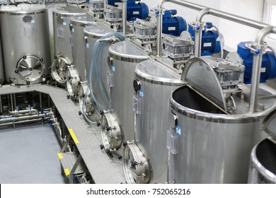 A Lot Of Stainless Steel Tanks With Large Round Hatches, Modern Beverage Production. Food Industry.