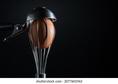 Stainless Steel Whisk With A Red Egg Inside And An Ice Cream Scoop On Top Simulating A Head With A Hat.