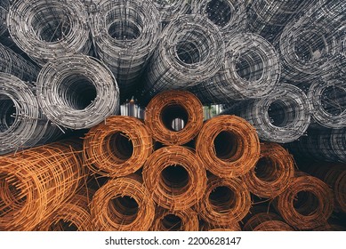 Stainless Steel Wire Rolls In Construction Site. Closeup Of Metal Steel Reinforcement Rod For Concrete In Store.Wire Mesh Places On Floor Ground. Construction Site Concept.