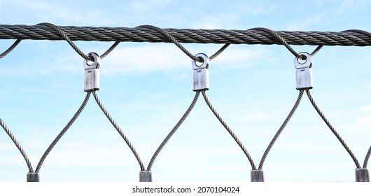 Stainless steel wire rope on a bridge parapet.