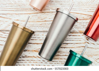 Stainless And Tumbler Cup On Wooden Background