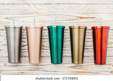 Stainless And Tumbler Cup On Wooden Background