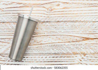 Stainless And Tumbler Cup On Wooden Background