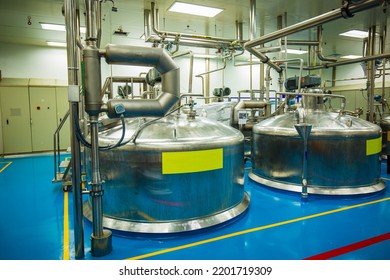 Stainless vertical steel tanks with equipment tank chemical cellar at the with stainless steel tanks cleaning and mixing at control room plant.