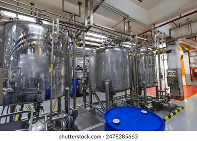 Stainless vertical steel tanks and pipes with pressure meter in equipment tank chemical cellar at the with stainless steel tanks - Powered by Shutterstock