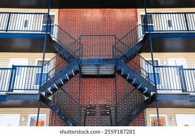 Staircase on a red brick wall of a modern apartment building - Powered by Shutterstock