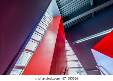 Staircase Painted In Red. Abstract Fragment Of Urban Architecture Of Modern Luxury Building, Hotel, Shopping Mall, Business Center.   Interior Design.