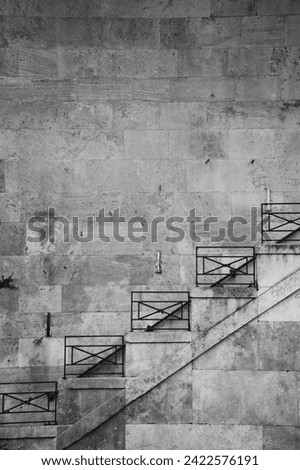 staircase of rod iron design hand rail on old weathered concrete block wall blank space for type travel background backdrop from Palermo Sicily italy ancient building square rod iron metal design 