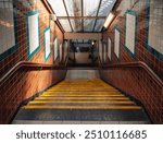 A staircase with steps going down on a subway station