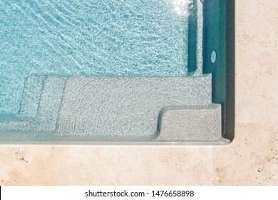 
A staircase under clear blue water goes down to the outdoor pool, a place for rest and relaxation in the pool, pool steps, close-ups of the pool, fragments, abstract geometry, underwater steps. - Powered by Shutterstock