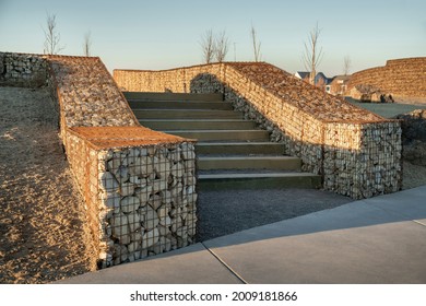Staircase with wooden riser in between the gabion retaining walls