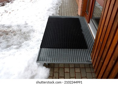 staircases made of steel gratings with rubber anti-slip mats. the mat at the cottage is on a raised staircase, snow removal from ski boots is much easier. winter surroundings of a mountain hut - Powered by Shutterstock