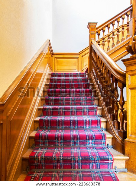 Stairs with\
carpet strip, old wooden\
staircase