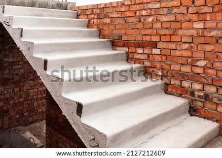 Stairs in Construction Building. Concrete Stairs. Staircase under construction. Unfinished building.  Stairway Construction. Brick wall