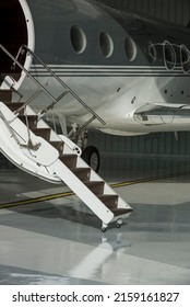 Stairs And Door Private Jet In Hangar Ready To Fly- Stock Photo