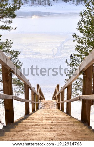 Stairs to the frozen lake in winter. Ogre, Latvia.