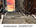 The stairs of the Joker in an orange sunrise or sunset in the famous neighborhood of The Bronx, the famous borough of New York in USA.