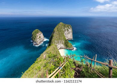 Stairs leading down to secluded Kelingking Beach on Nusa Penida, Indonesia.