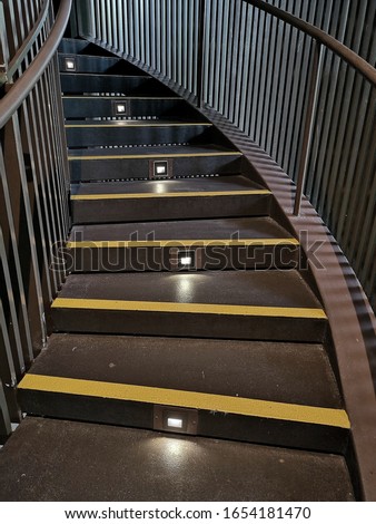 Stairs with lighting and yellow anti-slip treads and nosings. 