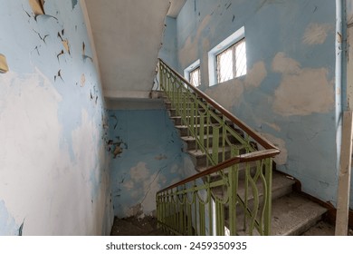 Stairs with metallic rail in abandoned building. Stairway inside an old house. - Powered by Shutterstock