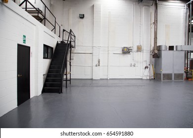 Stairs To Mezzanine Floor In Vast Empty Warehouse