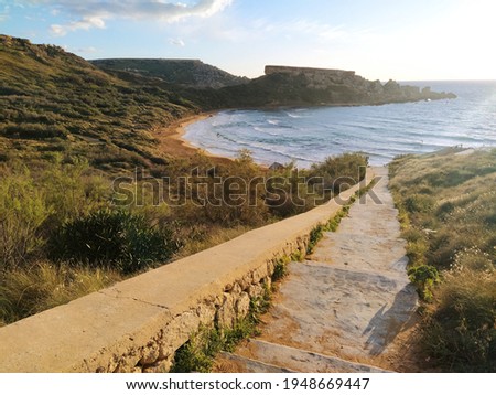 Stairs path to Ghajn Tuffieha (Riviera) Beach in  Mġarr, Island of Malta in the Mediterranean Sea, South Europe. Beautiful sandy beach - ideal destination for a summer vacation. Travel tourism image.