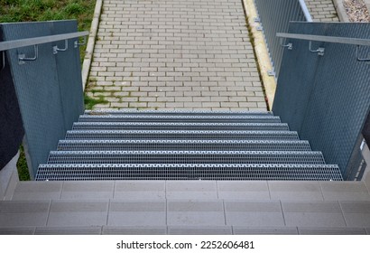 Stairs to a residential building made of stainless steel grid. galvanized stair grating made of expanded metal. lawn concrete sidewalk.  - Shutterstock ID 2252606481