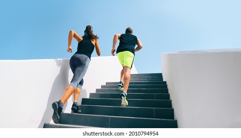 Stairs runners running up staircase training hiit workout. Couple working out legs and cardio at fitness gym. Healthy active lifestyle sport people exercising climbing staircase in urban city. - Powered by Shutterstock