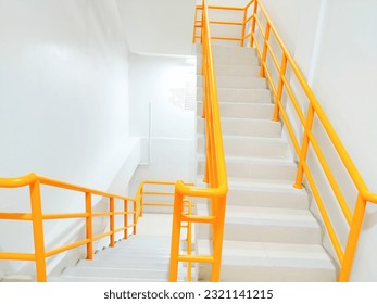 stairs with yellow railings inside the building