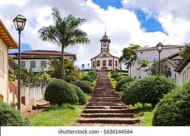 Stairway to a colonial chapel on top of a hill, lined by green trees and buildings in historical town Serro on a sunny day, Minas Gerais, Brazil - Shutterstock ID 1636144564