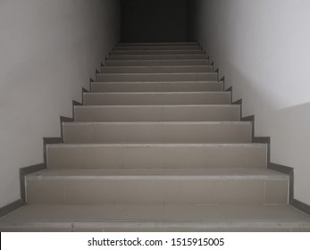 Stairway To The Top Of A Tall Building. Fire Escape Stairs In Low-light Buildings.