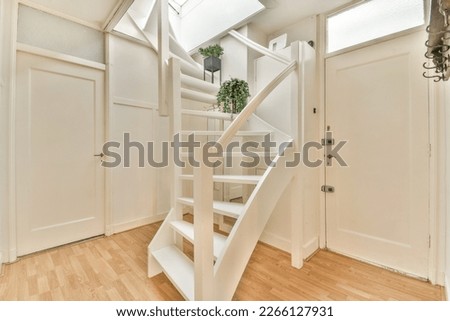 a stairway way in a house with wood floors and white trim on the walls, there is a mirror above it
