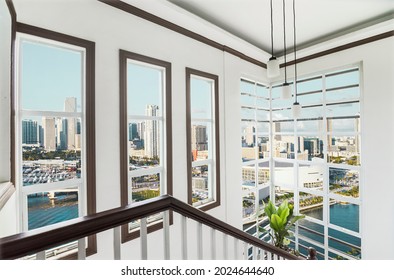 The stairwell of an upscale loft condo unit with views of Miami skyline. Interior of a luxury real estate property in South Florida.