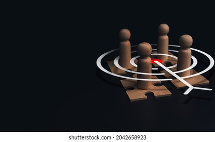 Stakeholder, business connection, teamwork, and team building concept. Close-up wooden figure, as businessman on jigsaw puzzles with target icon symbol on dark background with copy space.