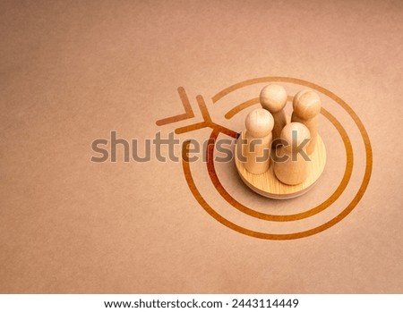 Stakeholder, business connection, teamwork, and team building concept. Four wooden figures as businessman standing together on round podium and target icon on brown recycle background with copy space.