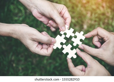 Stakeholders Business People Team Holding Jigsaw Puzzle As Team Building Union & Organization Connection Symbol. Teamwork, Connection, Mergers & Acquisitions  Concept.