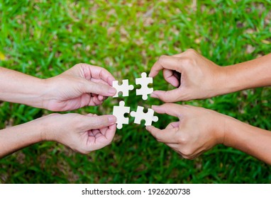 Stakeholders Business Team Hands Holding  Jigsaw Puzzle  As Collaboration,connection And Teamwork For Business Growth, Business Solution Concept.selective Focus.