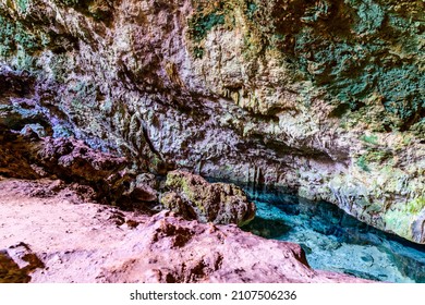 Stalactites and stalagmites in Kuza cave at Zanzibar, Tanzania. Natural pool with crystal clear water