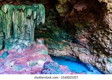 Stalactites and stalagmites in Kuza cave at Zanzibar, Tanzania. Natural pool with crystal clear water