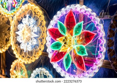 A stall by the street selling various lighted Christmas Parols. Parols are a traditional Filipino Christmas lantern illuminated with led lights. - Powered by Shutterstock