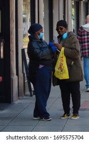 Stamford, Connecticut / USA - April 5, 2020:People Fearing Coronavirus Wearing Protective Face-masks On The Empty Streets Of Downtown Stamford. 