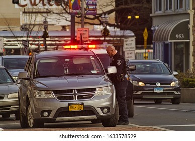 Stamford, Connecticut /USA - Circa December 2019:Stamford Police Officer Conducting A Traffic Stop On A Busy Morning In The Stamford Business District.