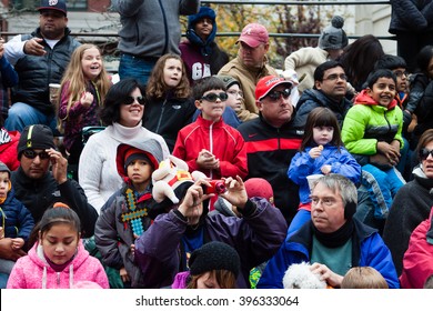 Stamford, CT, USA - November 22, 2015: Spectators enjoying the annual "Thanksgiving Day" parade in downtown Stamford on November 22, 2015.