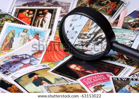 Stamp collection with magnifying glass, shallow depth of field