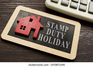 Stamp duty land tax holiday and model of house. - Shutterstock ID 1970871590