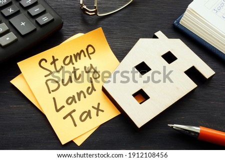 Stamp duty land tax SDLT memo and model of home.