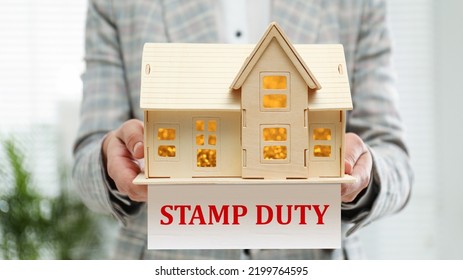 Stamp duty. Woman holding wooden house model, closeup - Shutterstock ID 2199764595