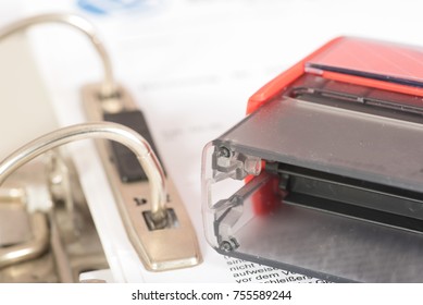 A stamp and a folder with documents