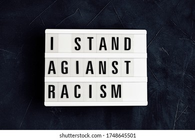 I Stand Against Racism  Text On Light Box Over Dark Background