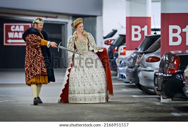 Stand back\
mlady, Ill deal with these creatures. A king and queen in a parking\
garage viewing cars\
suspiciously.